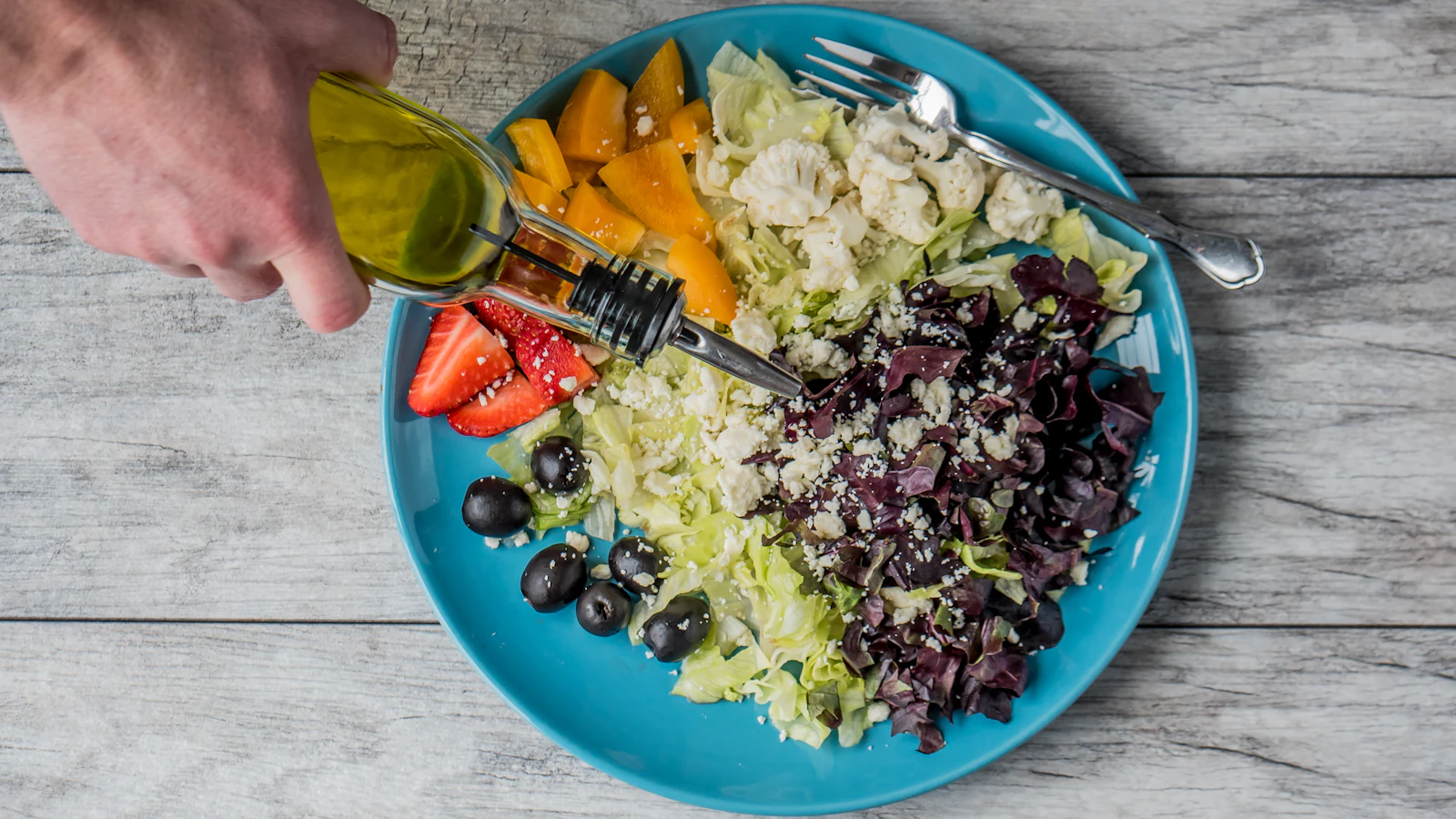 best olive oil for cooking drizzled over a fresh salad